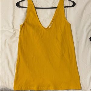Mustard yellow V-neck tee.